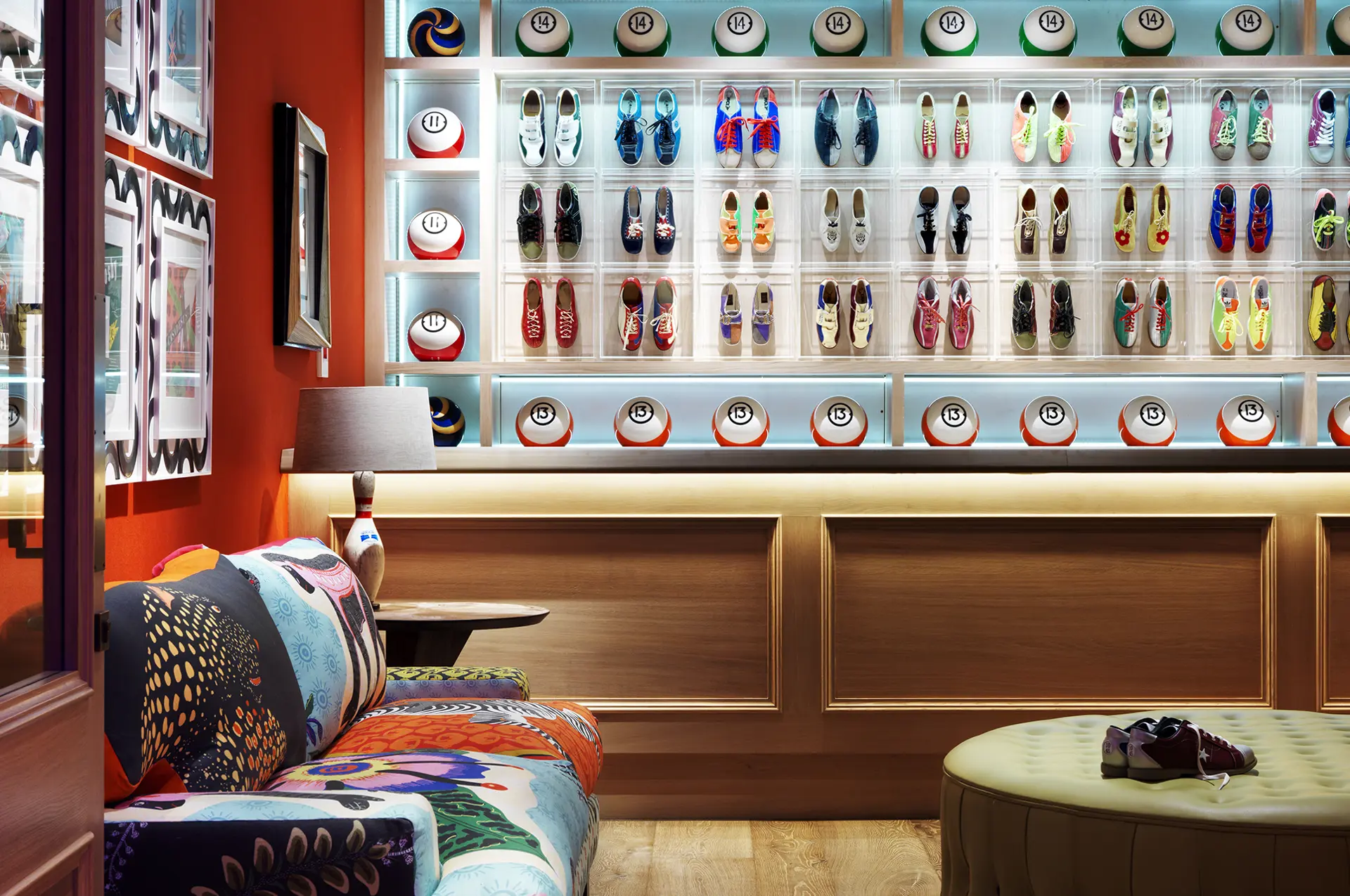 The Croc bowling alley at Ham Yard Hotel — colourful bowling shoes on display, numbered bowling balls, and a richly upholstered sofa